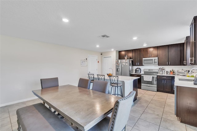 dining space with light tile floors