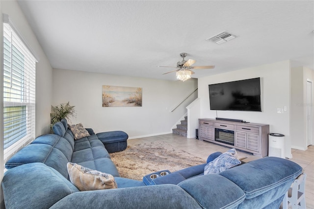 living room with ceiling fan and light tile floors