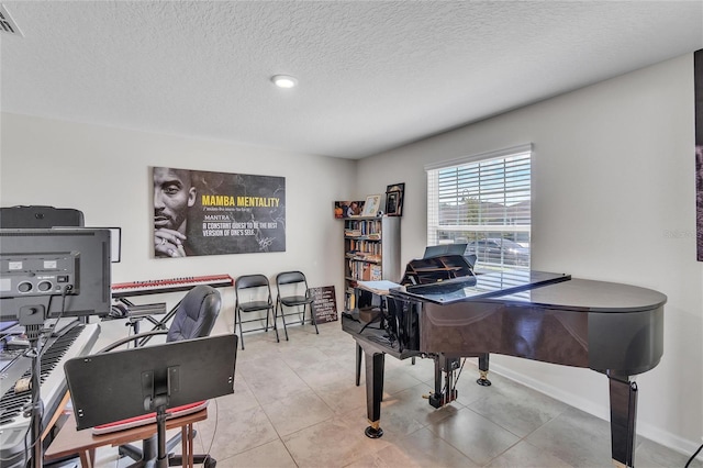 misc room featuring light tile floors and a textured ceiling