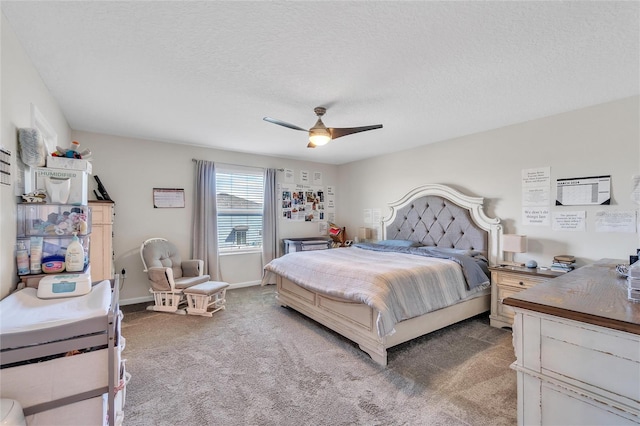 carpeted bedroom featuring ceiling fan and a textured ceiling