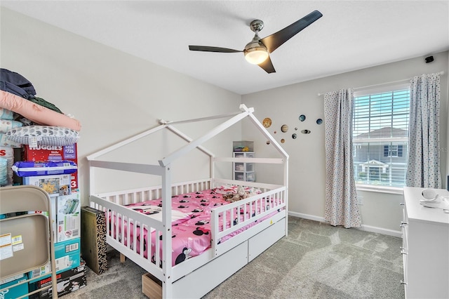 bedroom with ceiling fan and dark carpet