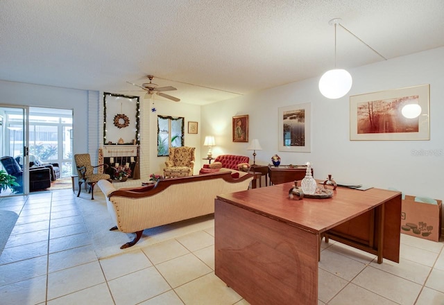 living room with light tile floors, a textured ceiling, brick wall, and ceiling fan