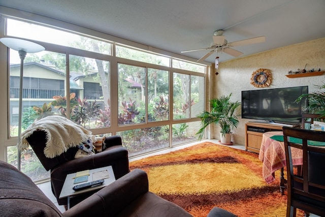 sunroom / solarium featuring plenty of natural light and ceiling fan