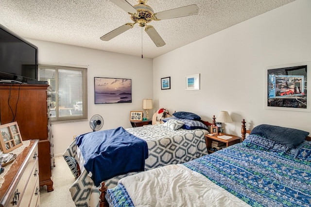 carpeted bedroom with a textured ceiling and ceiling fan