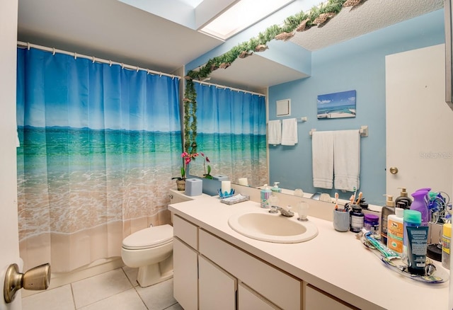 bathroom featuring toilet, a textured ceiling, vanity, and tile flooring