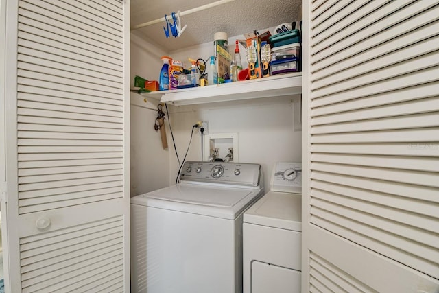 laundry area featuring hookup for a washing machine, washer and clothes dryer, and a textured ceiling