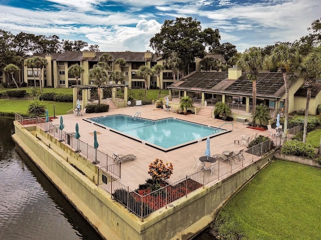 view of swimming pool featuring a lawn and a patio