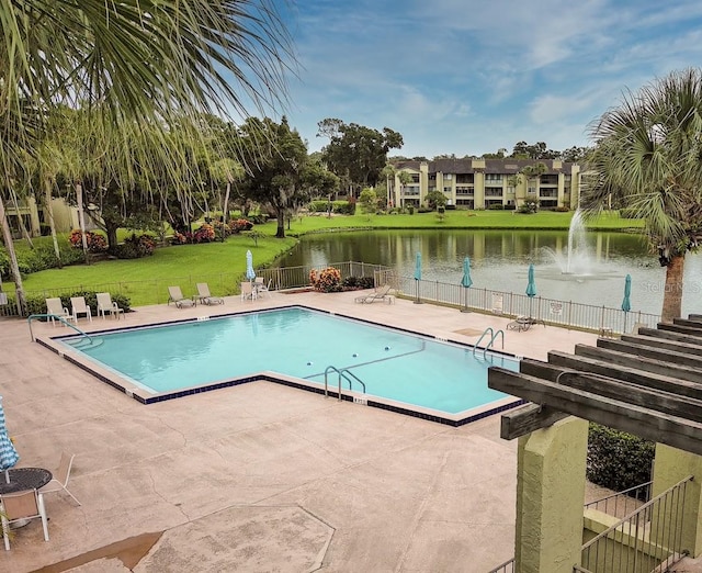 view of swimming pool featuring a patio and a yard