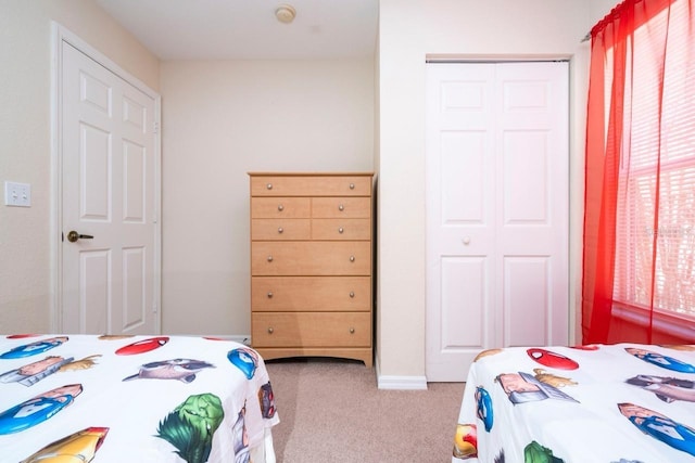 carpeted bedroom with a closet