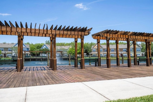 view of dock with a water view and a pergola