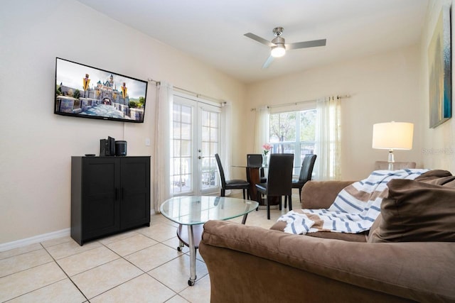 living room featuring light tile patterned flooring, ceiling fan, and french doors