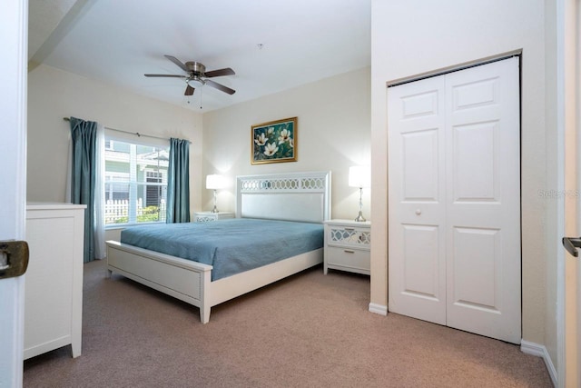 carpeted bedroom featuring a closet and ceiling fan