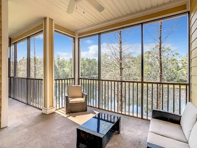 unfurnished sunroom with ceiling fan