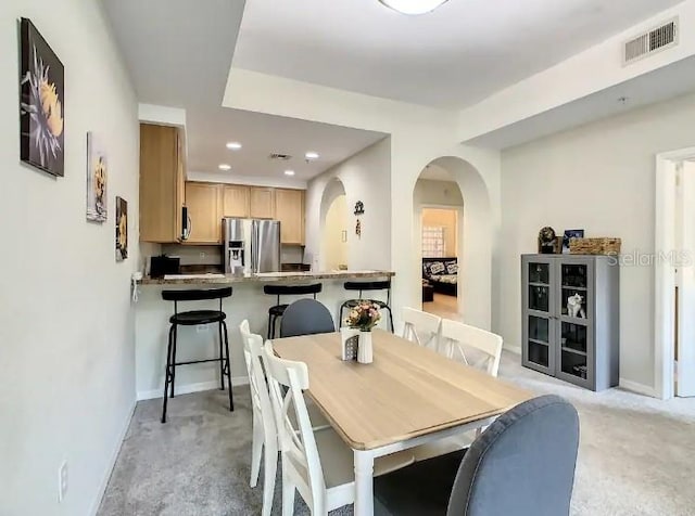 dining space featuring light colored carpet