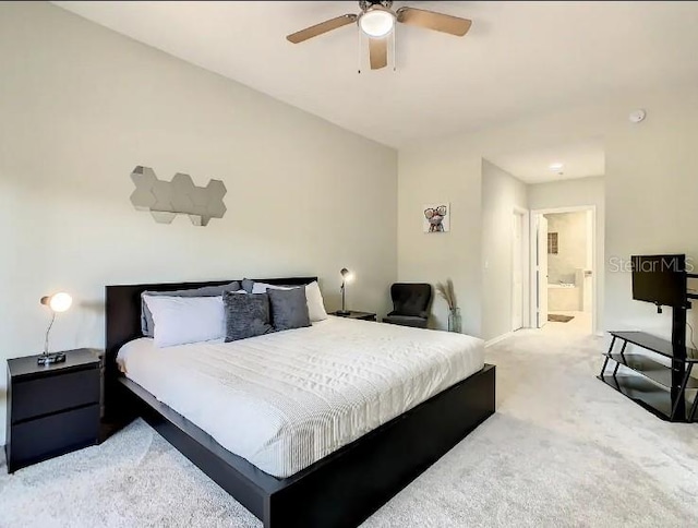 bedroom with light colored carpet, ensuite bathroom, and ceiling fan