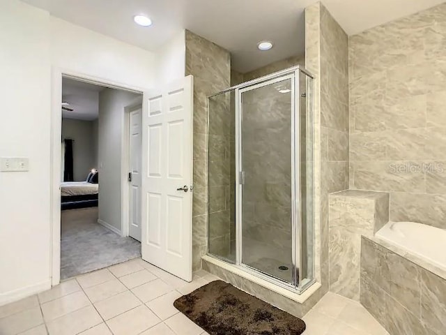 bathroom featuring shower with separate bathtub and tile floors