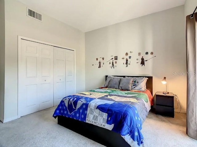 bedroom featuring light carpet and a closet