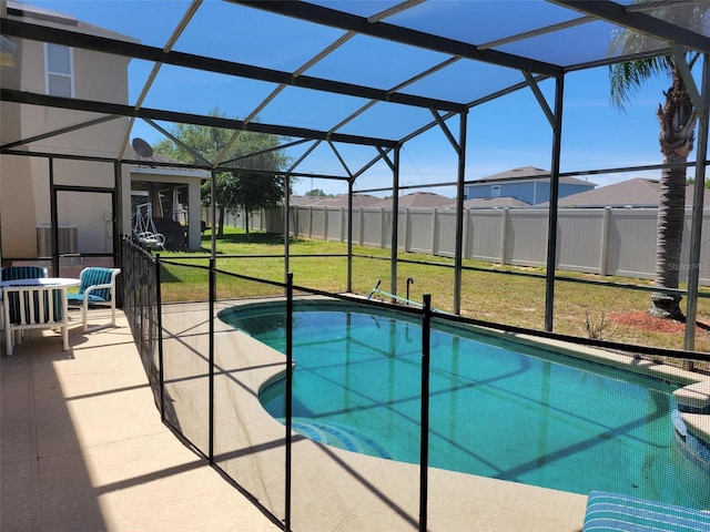 view of pool featuring a lanai, a lawn, and a patio