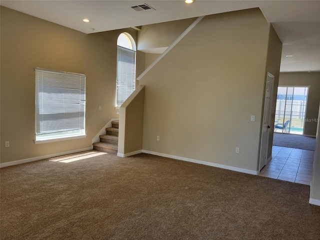 unfurnished living room featuring light carpet