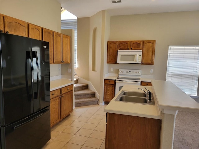 kitchen with white appliances, light tile flooring, sink, and a kitchen island with sink