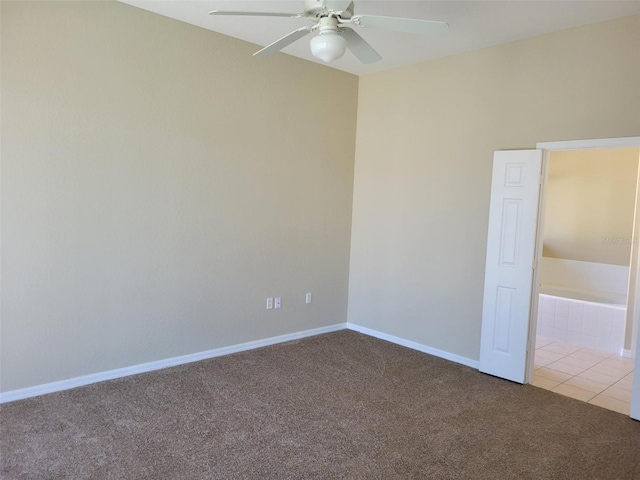 carpeted spare room featuring ceiling fan