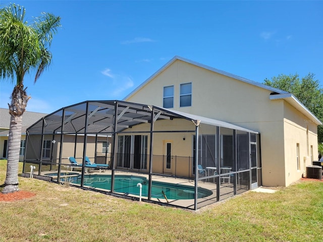 back of property featuring a yard, a patio area, a lanai, and central AC unit