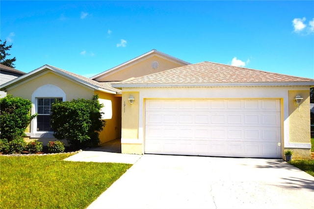 view of front of house with a front yard and a garage