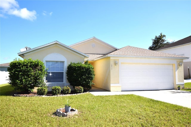 view of front of home with a front yard and a garage