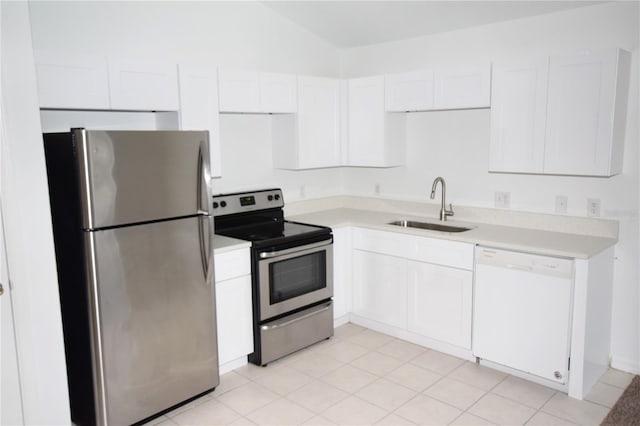 kitchen with white cabinets, stainless steel appliances, light tile floors, and sink