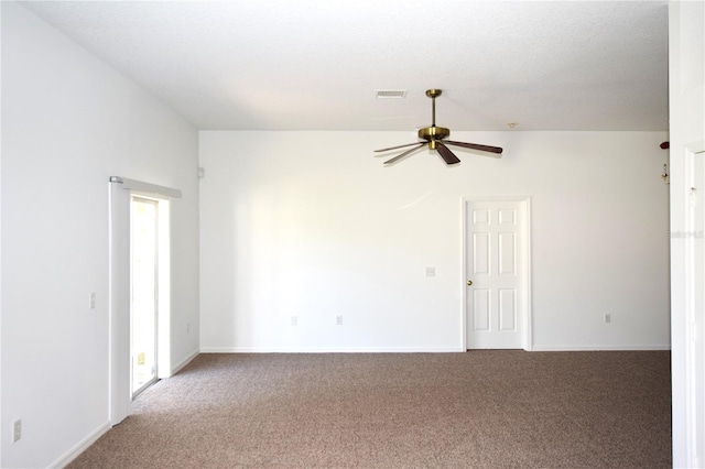 carpeted spare room with lofted ceiling and ceiling fan