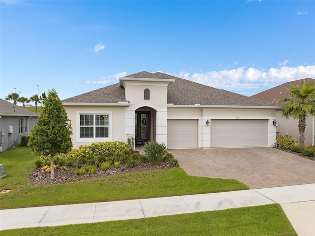 view of front of home with a garage and a front yard