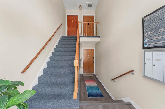 stairs featuring hardwood / wood-style floors