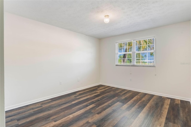 unfurnished room with a textured ceiling and dark hardwood / wood-style flooring