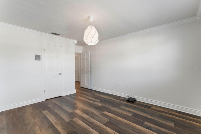 spare room with crown molding and dark hardwood / wood-style floors