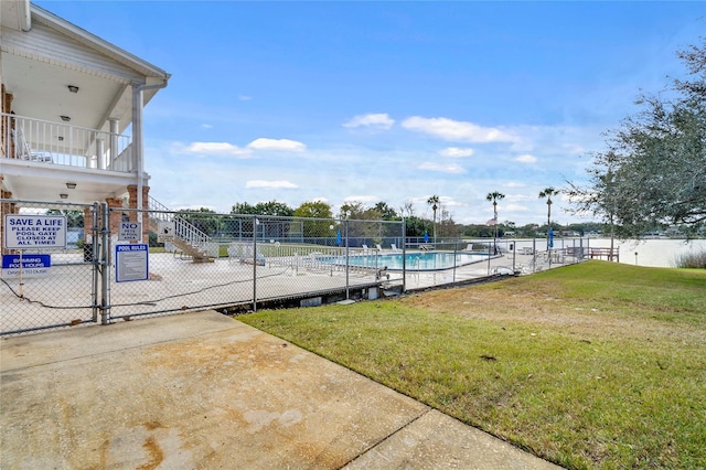 view of swimming pool featuring a patio area and a lawn