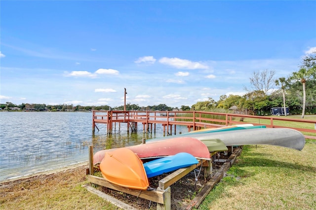 dock area with a water view and a yard