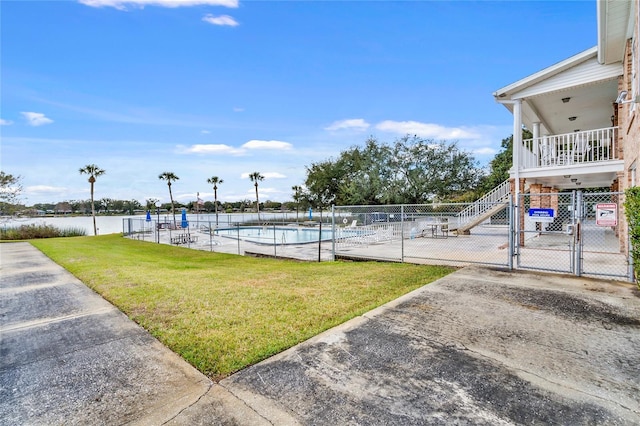 view of pool featuring a lawn