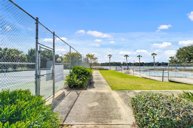 view of sport court featuring a community pool