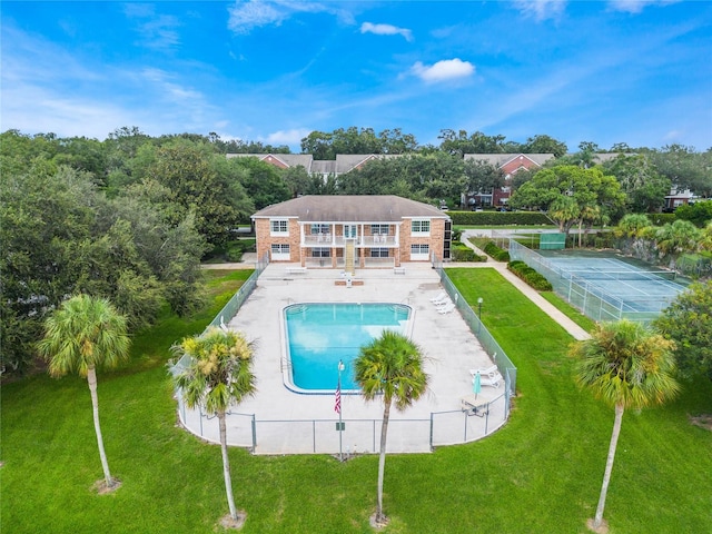 view of swimming pool featuring a patio and a lawn