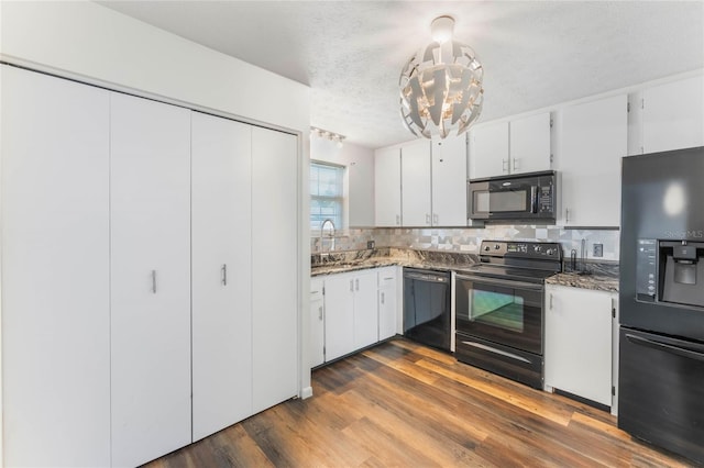 kitchen with decorative backsplash, white cabinets, dark hardwood / wood-style flooring, black appliances, and sink