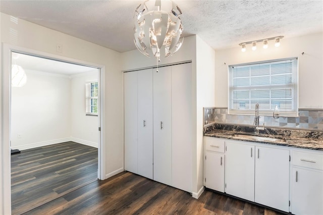 kitchen featuring decorative backsplash, white cabinetry, sink, and dark wood-type flooring