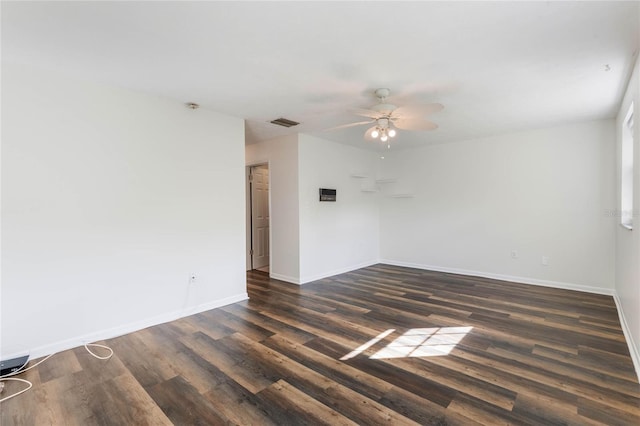 empty room featuring dark wood-type flooring and ceiling fan