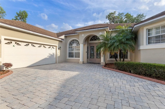 view of front of house with a garage and french doors