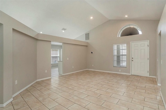 tiled entrance foyer with high vaulted ceiling