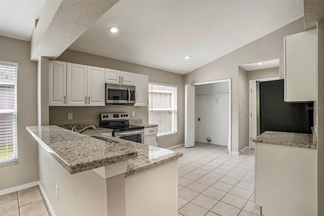 kitchen with light stone counters, sink, stainless steel appliances, and white cabinetry