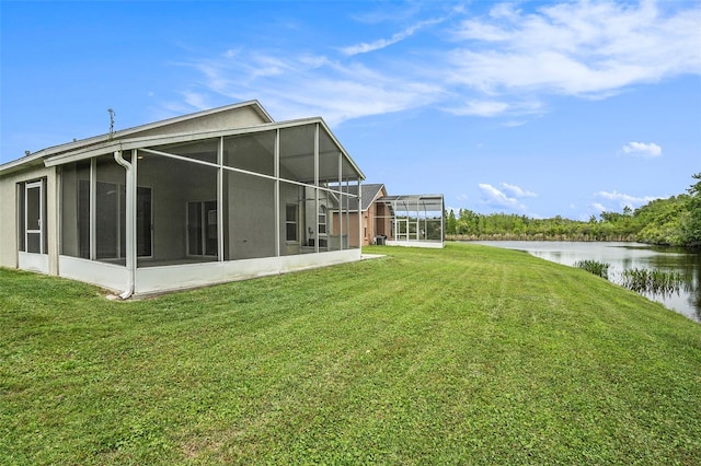 view of yard with a water view and a sunroom