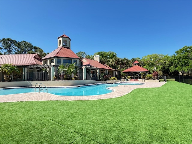 view of swimming pool with a lawn