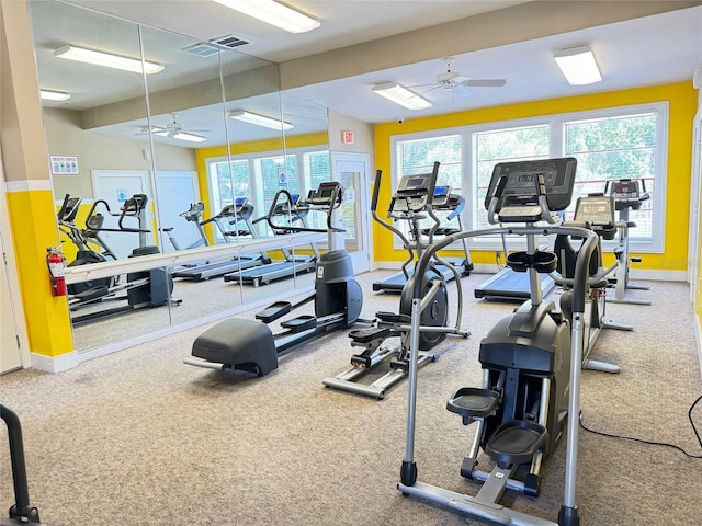 gym featuring carpet flooring, a healthy amount of sunlight, and ceiling fan