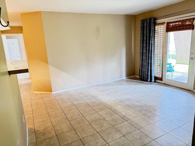 empty room with a wealth of natural light and light tile patterned floors