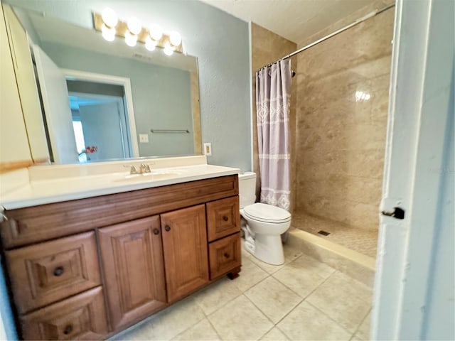 bathroom featuring tile patterned floors, a shower with curtain, toilet, and vanity